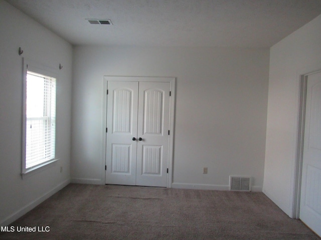 3542 Marcia Louise Dr, Southaven, MS 38672 - unfurnished bedroom featuring carpet, multiple windows, and a closet
