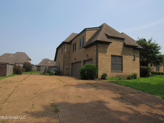 3542 Marcia Louise Dr, Southaven, MS 38672 - view of home's exterior featuring driveway, brick siding, a shingled roof, and a garage