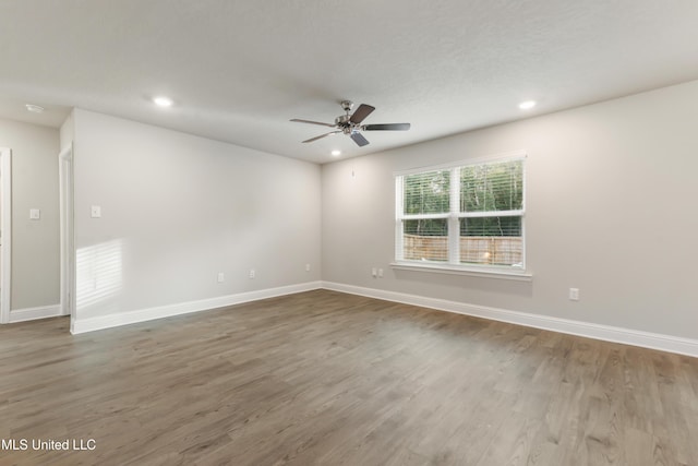 empty room featuring hardwood / wood-style floors and ceiling fan