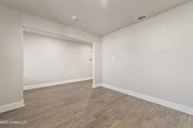 empty room with dark wood-type flooring