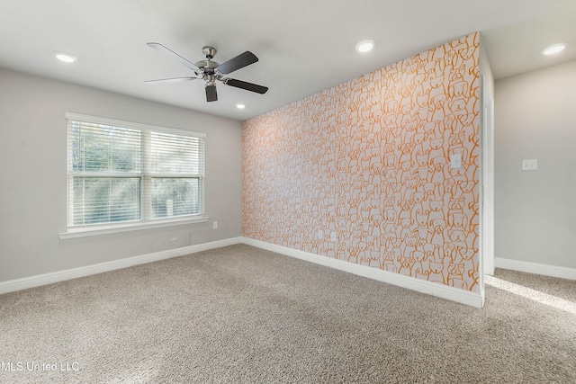 spare room with carpet flooring and ceiling fan