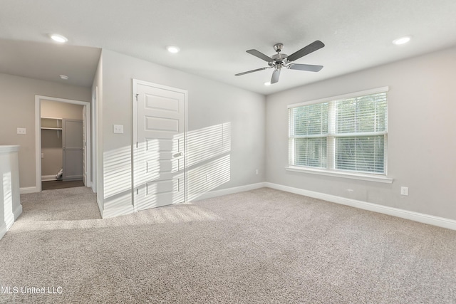 spare room with carpet and ceiling fan