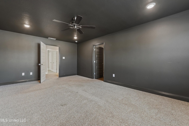 unfurnished room with ceiling fan and light carpet