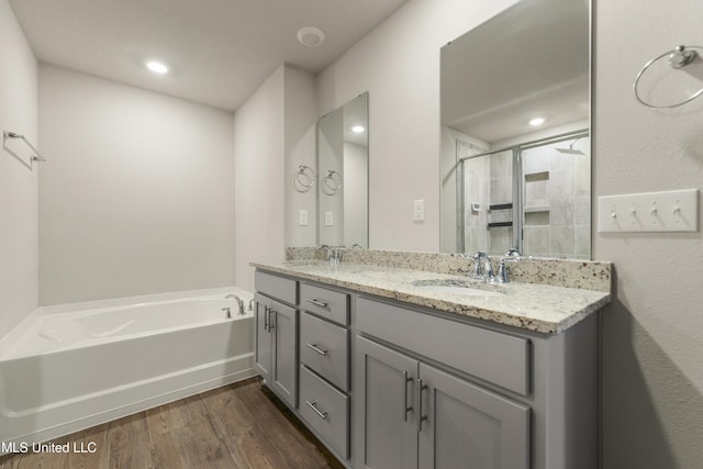 bathroom with vanity, shower with separate bathtub, and hardwood / wood-style flooring