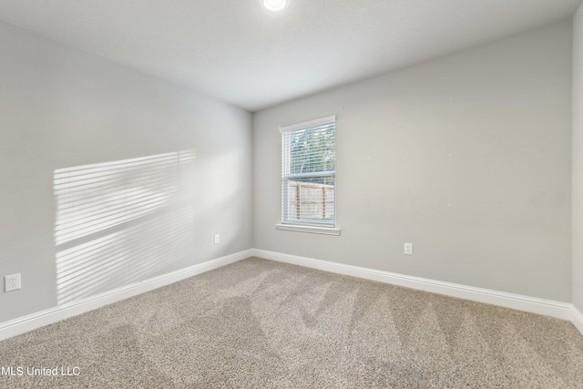 unfurnished room featuring carpet