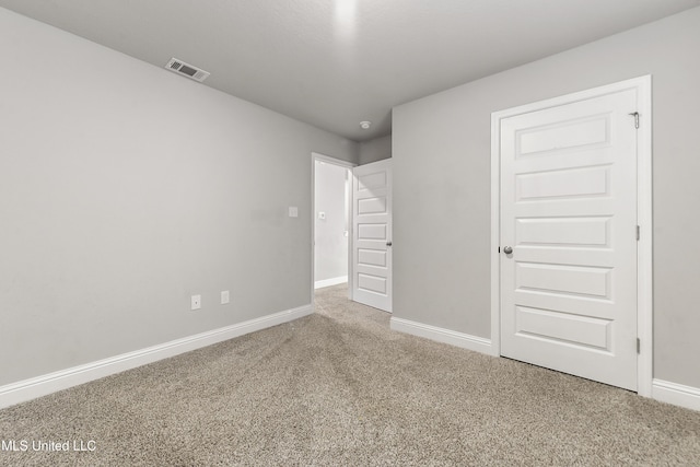 unfurnished bedroom featuring carpet and a closet