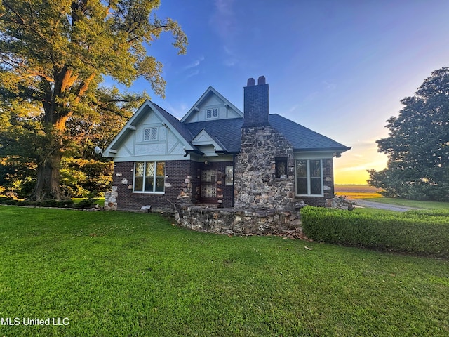 5228 Old Hwy 49, Clarksdale, MS 38614 - view of front of home with a front lawn, a chimney, and brick siding