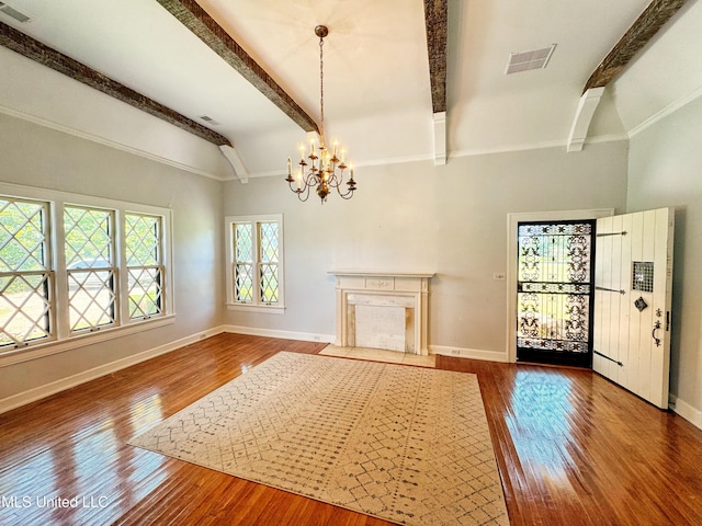 5228 Old Hwy 49, Clarksdale, MS 38614 - unfurnished living room featuring beam ceiling, a chandelier, wood finished floors, and baseboards