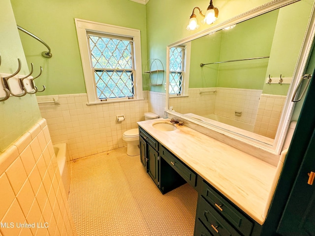5228 Old Hwy 49, Clarksdale, MS 38614 - bathroom with a garden tub, wainscoting, tile walls, vanity, and toilet