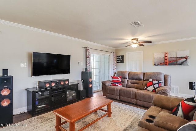 living area featuring baseboards, visible vents, ceiling fan, wood finished floors, and crown molding