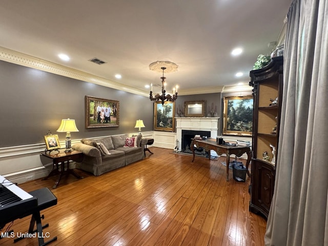 59 Dunbar Rd, Natchez, MS 39120 - living area featuring crown molding, a chandelier, hardwood / wood-style floors, a wainscoted wall, and a fireplace