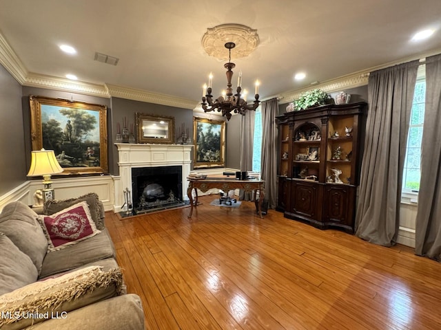 59 Dunbar Rd, Natchez, MS 39120 - living room featuring crown molding, a chandelier, hardwood / wood-style floors, a fireplace, and recessed lighting