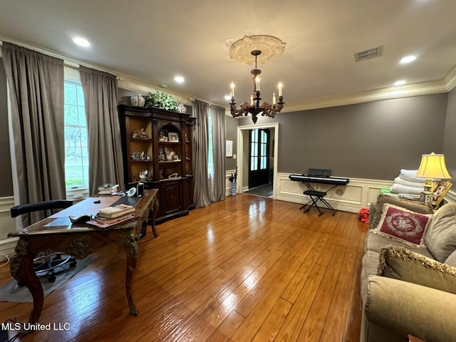 59 Dunbar Rd, Natchez, MS 39120 - living room featuring crown molding, a chandelier, wood-type flooring, a desk, and wainscoting