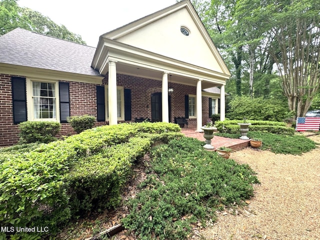 59 Dunbar Rd, Natchez, MS 39120 - view of front facade with brick siding and roof with shingles