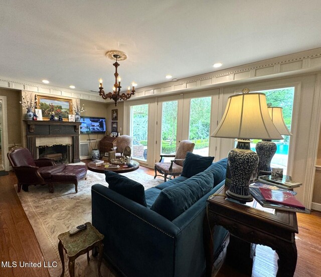 59 Dunbar Rd, Natchez, MS 39120 - living area featuring wood finished floors, a chandelier, and a fireplace