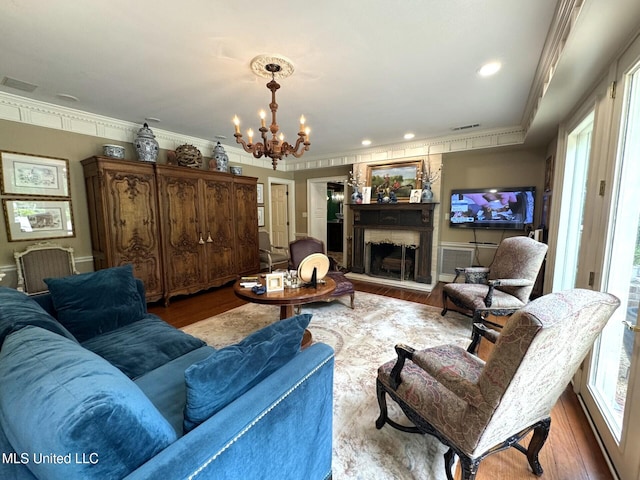 59 Dunbar Rd, Natchez, MS 39120 - living room with wood finished floors, a chandelier, crown molding, and a fireplace