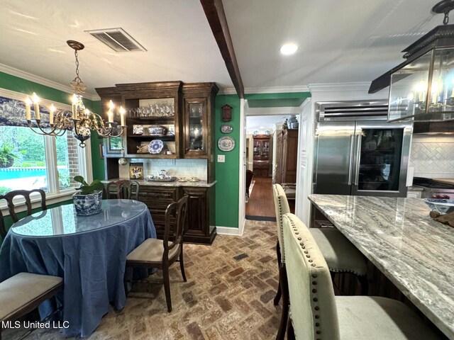 59 Dunbar Rd, Natchez, MS 39120 - dining space featuring brick flooring, a chandelier, ornamental molding, baseboards, and recessed lighting