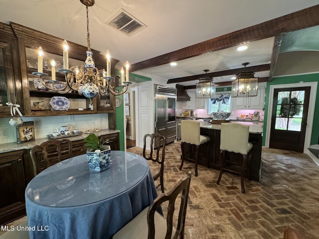 59 Dunbar Rd, Natchez, MS 39120 - dining area featuring a chandelier, brick floors, beamed ceiling, and recessed lighting