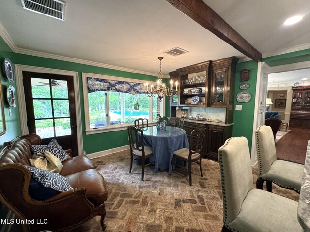 59 Dunbar Rd, Natchez, MS 39120 - dining space with brick flooring, healthy amount of natural light, a chandelier, baseboards, and crown molding