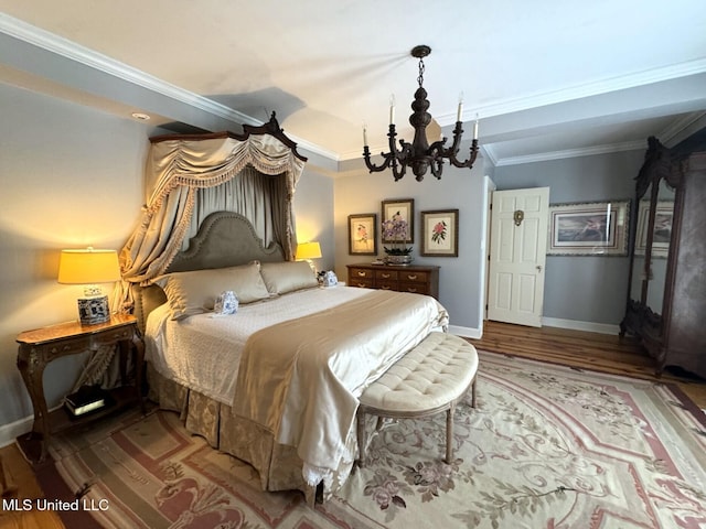 59 Dunbar Rd, Natchez, MS 39120 - bedroom with a chandelier, ornamental molding, wood finished floors, and baseboards
