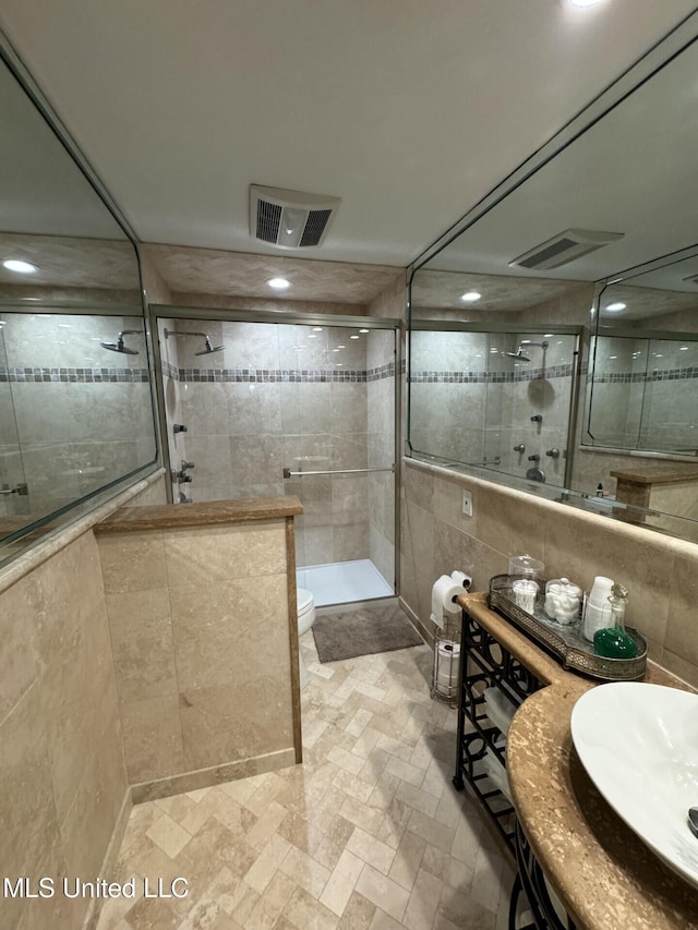 59 Dunbar Rd, Natchez, MS 39120 - bathroom with tile walls, a shower stall, toilet, and a sink