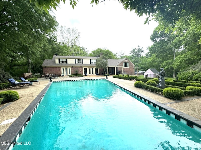 59 Dunbar Rd, Natchez, MS 39120 - swimming pool featuring french doors, a patio area, and view of wooded area