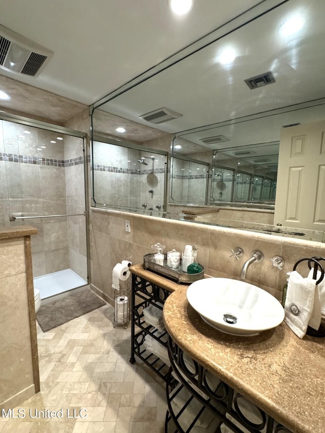 59 Dunbar Rd, Natchez, MS 39120 - full bath with tile walls, a sink, a shower stall, recessed lighting, and decorative backsplash