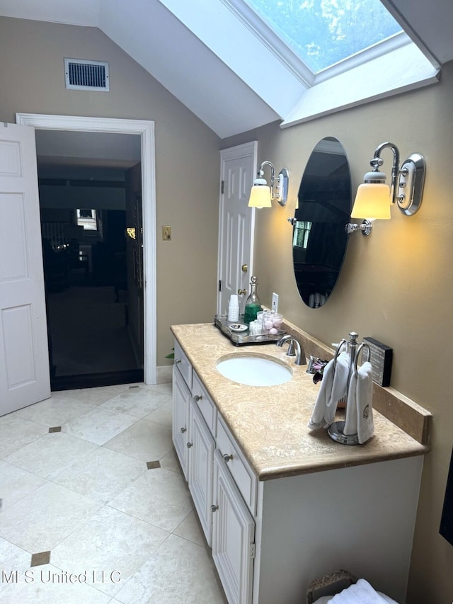 59 Dunbar Rd, Natchez, MS 39120 - bathroom with a skylight, vaulted ceiling, vanity, and tile patterned floors