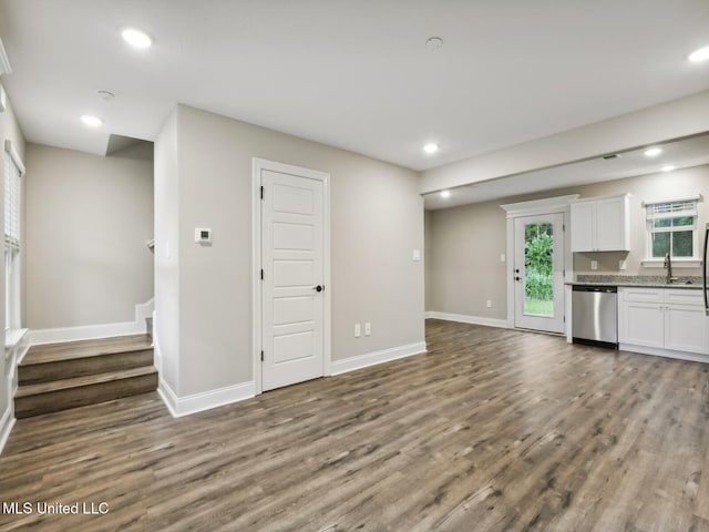 13454 Kelly St, Gulfport, MS 39503 - unfurnished living room with dark wood-type flooring, baseboards, recessed lighting, stairway, and a sink