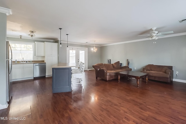 living room featuring crown molding, dark hardwood / wood-style floors, sink, and french doors