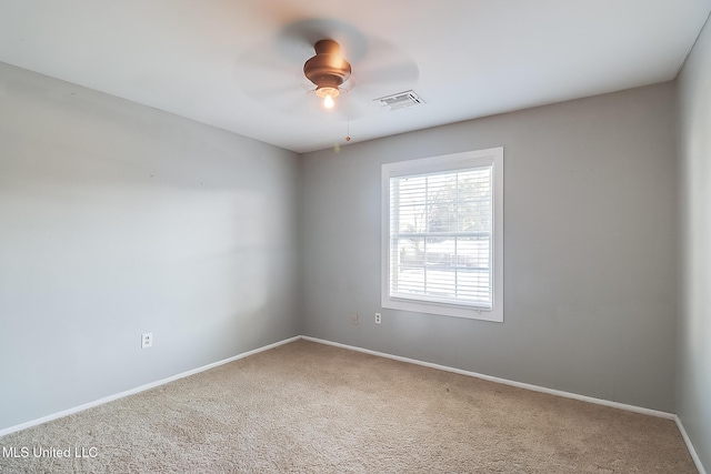 carpeted empty room featuring ceiling fan