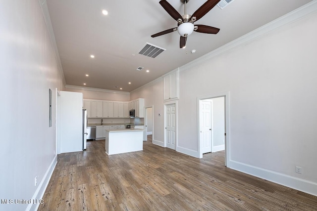 433 Main St, Natchez, MS 39120 - unfurnished living room with ornamental molding, a ceiling fan, wood finished floors, and recessed lighting