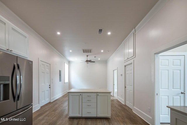 433 Main St, Natchez, MS 39120 - kitchen featuring stainless steel refrigerator with ice dispenser, a ceiling fan, dark wood finished floors, a kitchen island, and ornamental molding