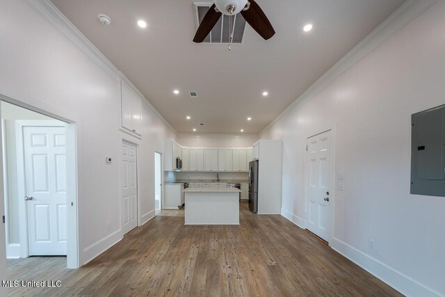 433 Main St, Natchez, MS 39120 - kitchen with appliances with stainless steel finishes, electric panel, ceiling fan, a center island, and wood finished floors