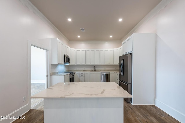 433 Main St, Natchez, MS 39120 - kitchen with stainless steel appliances, dark wood finished floors, light stone countertops, ornamental molding, and recessed lighting