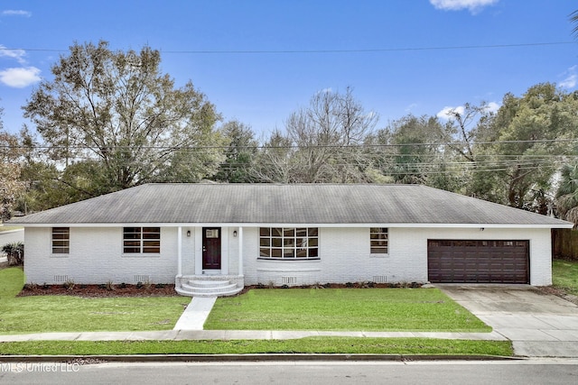 ranch-style home featuring a garage and a front yard