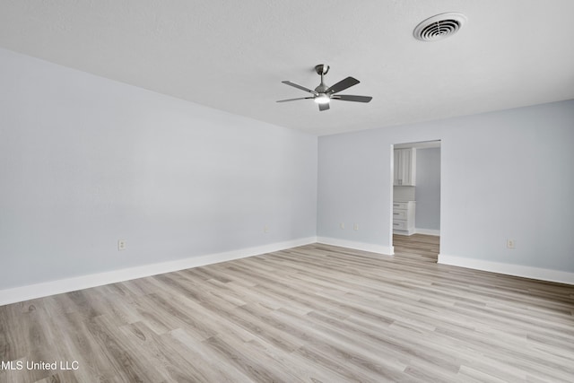 spare room with ceiling fan and light hardwood / wood-style floors