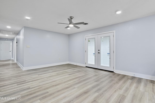 spare room with light hardwood / wood-style flooring, ceiling fan, and french doors