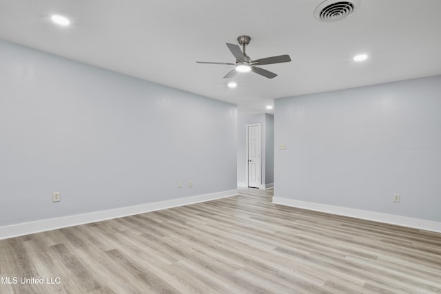 spare room with ceiling fan and light wood-type flooring