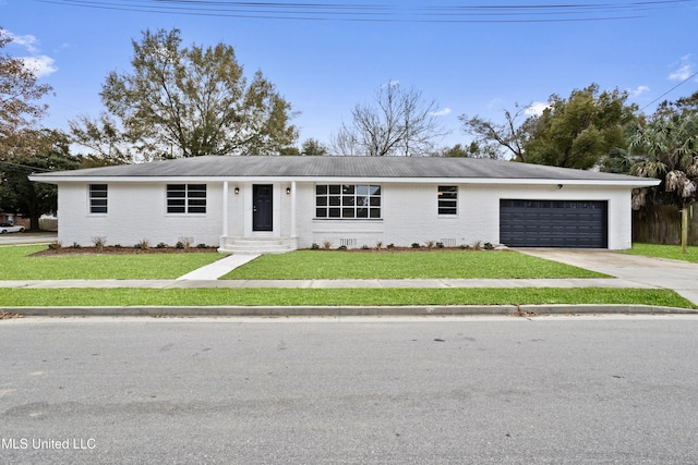 ranch-style home featuring a garage and a front lawn