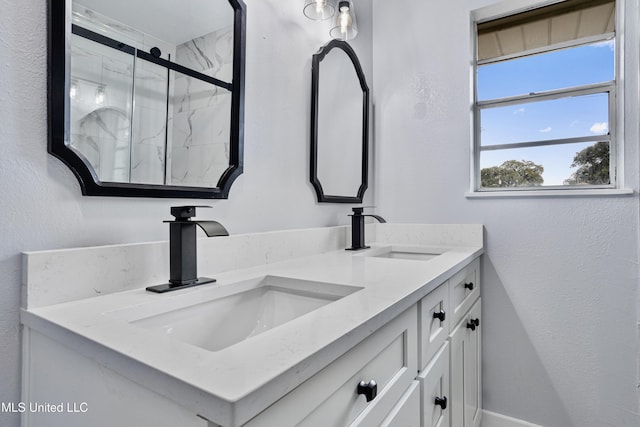 bathroom with a shower with door and vanity