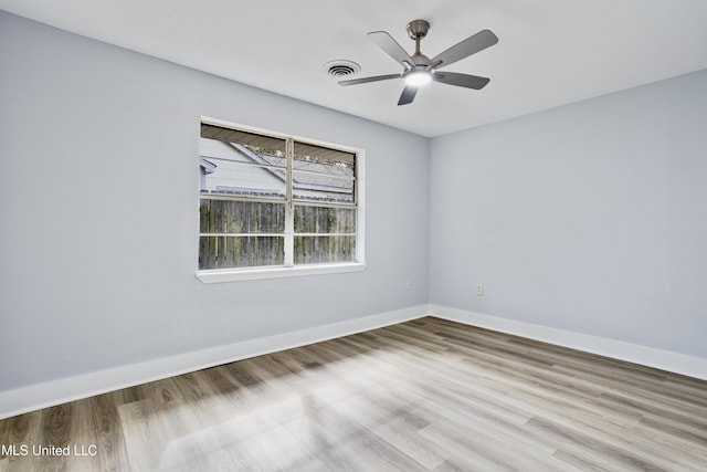 empty room with ceiling fan and wood-type flooring