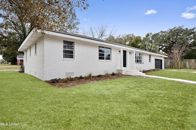 ranch-style house with a garage and a front yard