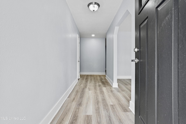 hallway with light hardwood / wood-style flooring