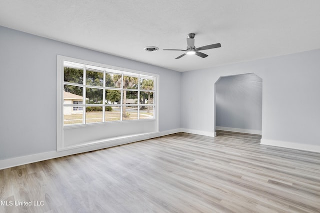 empty room with ceiling fan and light wood-type flooring