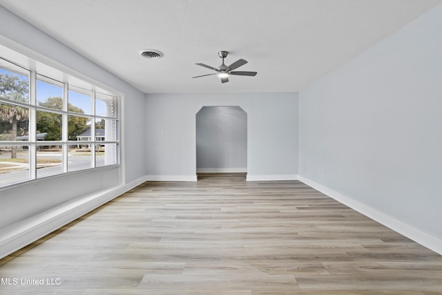 empty room featuring ceiling fan and light hardwood / wood-style flooring