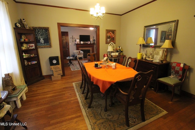 865 Fairfield Ave, Grenada, MS 38901 - dining space featuring hardwood / wood-style flooring, ornamental molding, and an inviting chandelier