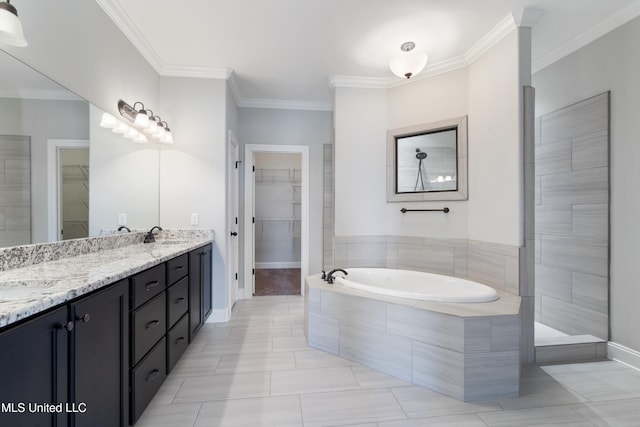 bathroom with double vanity, a garden tub, a walk in closet, crown molding, and a sink