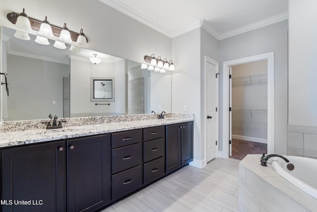 full bath featuring double vanity, ornamental molding, a sink, and a walk in closet