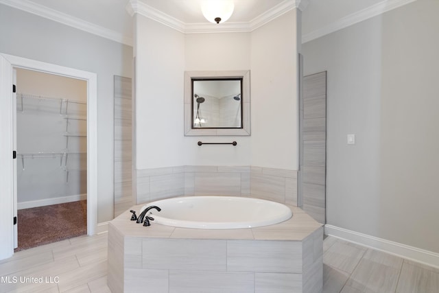 bathroom featuring crown molding, a spacious closet, tiled shower, baseboards, and a bath